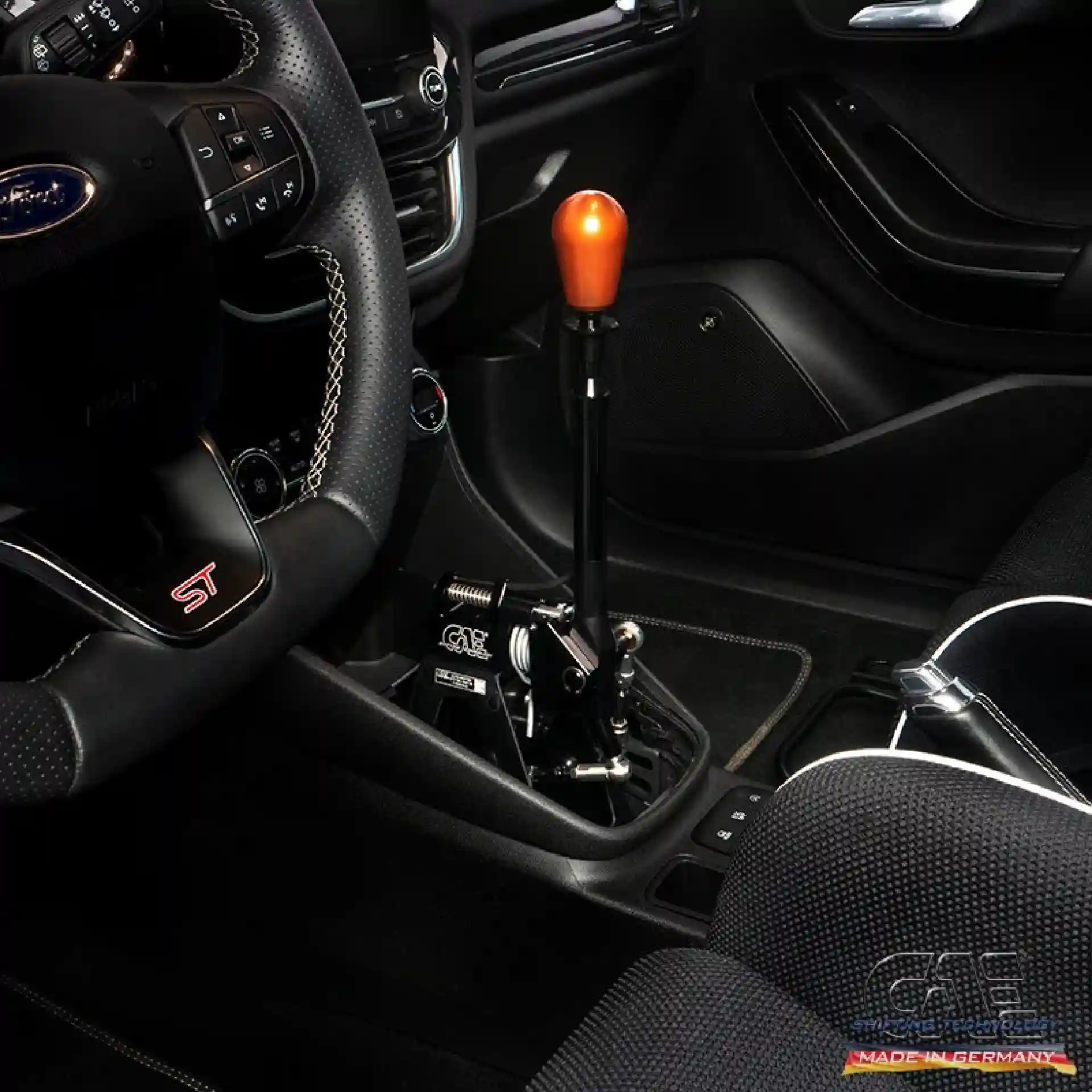 Close-up of a CAE Ultra Shifter in the sporty cockpit of a Mazda RX-8.