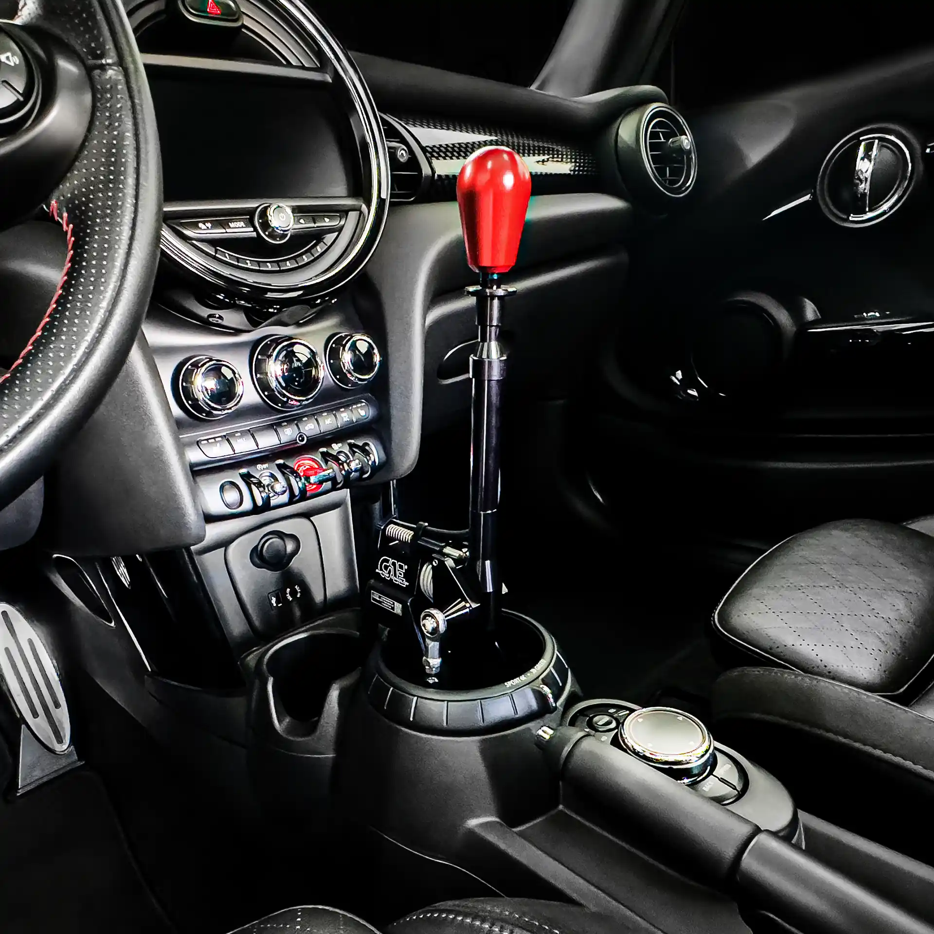 HDR photo of the interior of a Mini Cooper S featuring an installed, black-anodized CAE Ultra Shifter with a red shift knob.